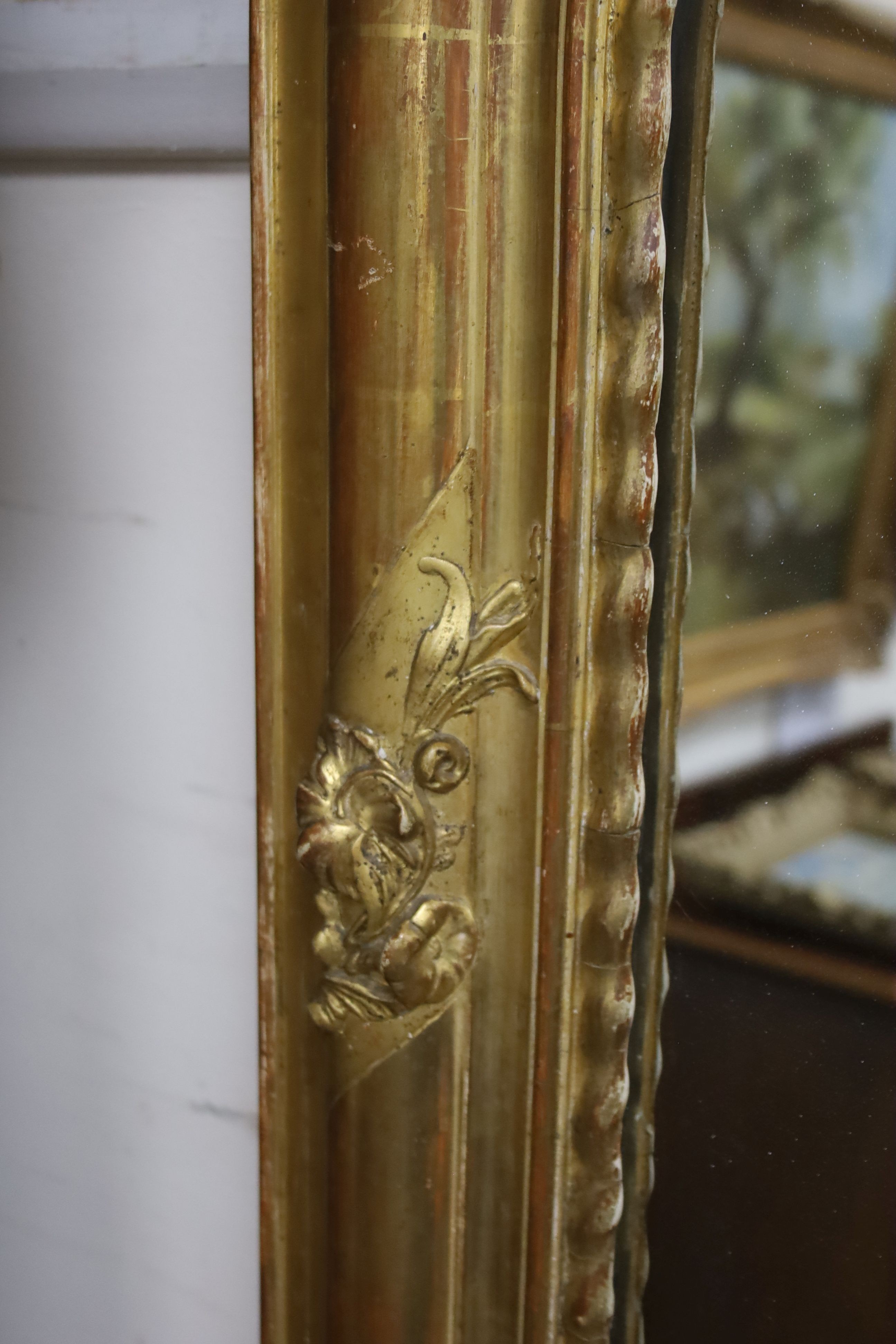 A 19th century French overmantel mirror, giltwood and gesso with channelled frame and scroll with cabochon crest detail, width 98cm, height 164cm